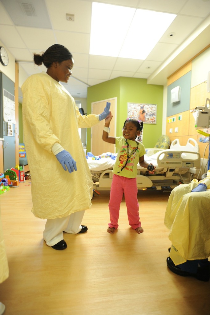 a nurse with a child in a hospital