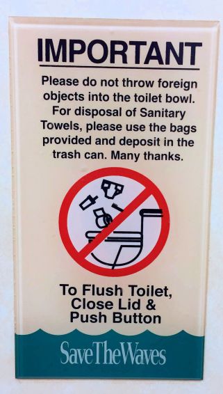 a sign- IMPORTANT-please do not throw foreign objects into the toilet bowl.