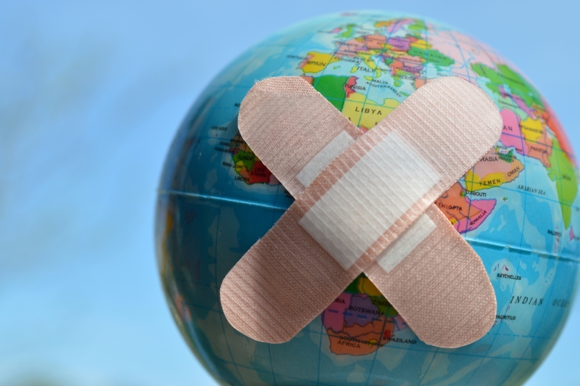 2 bandaids crossed on a world globe